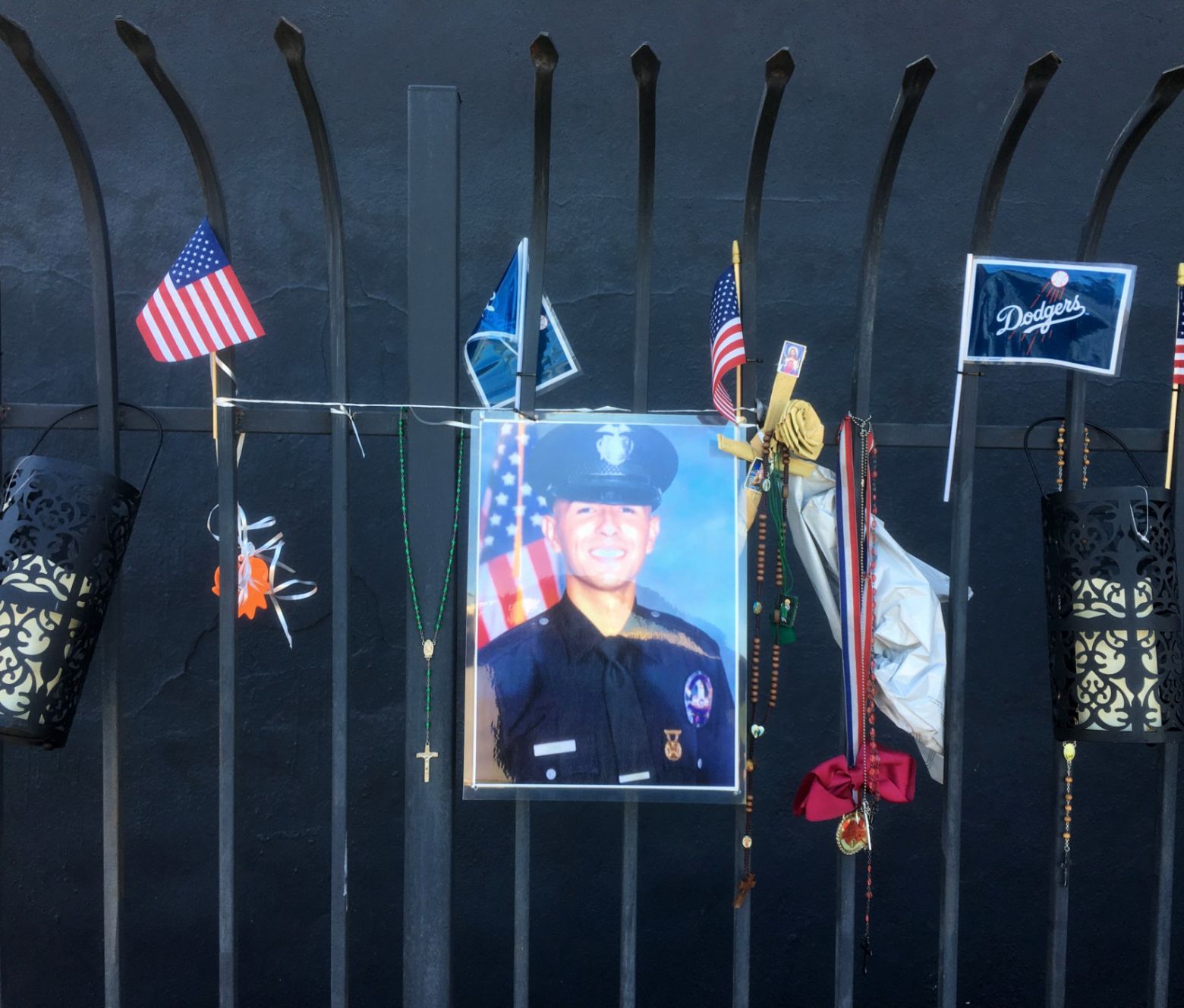 Memorial to Juan Jose Diaz hanging from a fence in Lincoln Heights